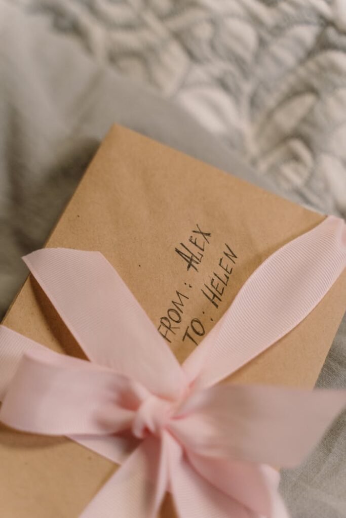 Close-Up Shot of Postcards Wrapped in a Pink Ribbon